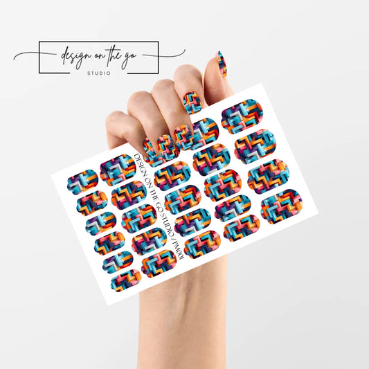 #type_manicure single hand with beautifully manicured nails with nail wraps holding full nail wraps sheet.