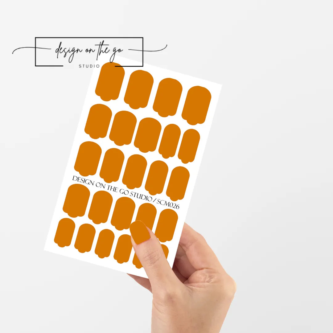 #type_manicure single hand with beautifully manicured nails with nail wraps holding full nail wraps sheet.