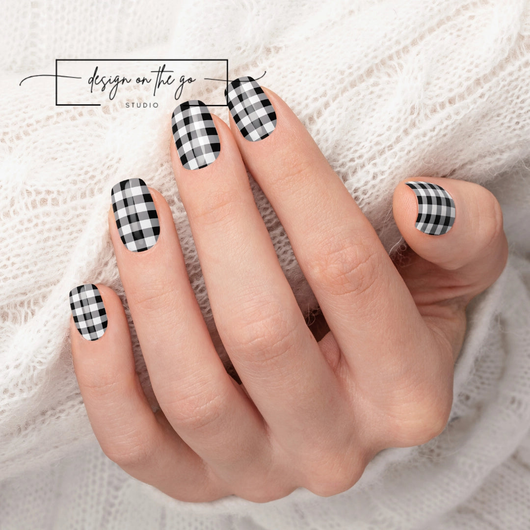 #type_manicure beautifully manicured hand showing nails with nail wraps applied on white sweater