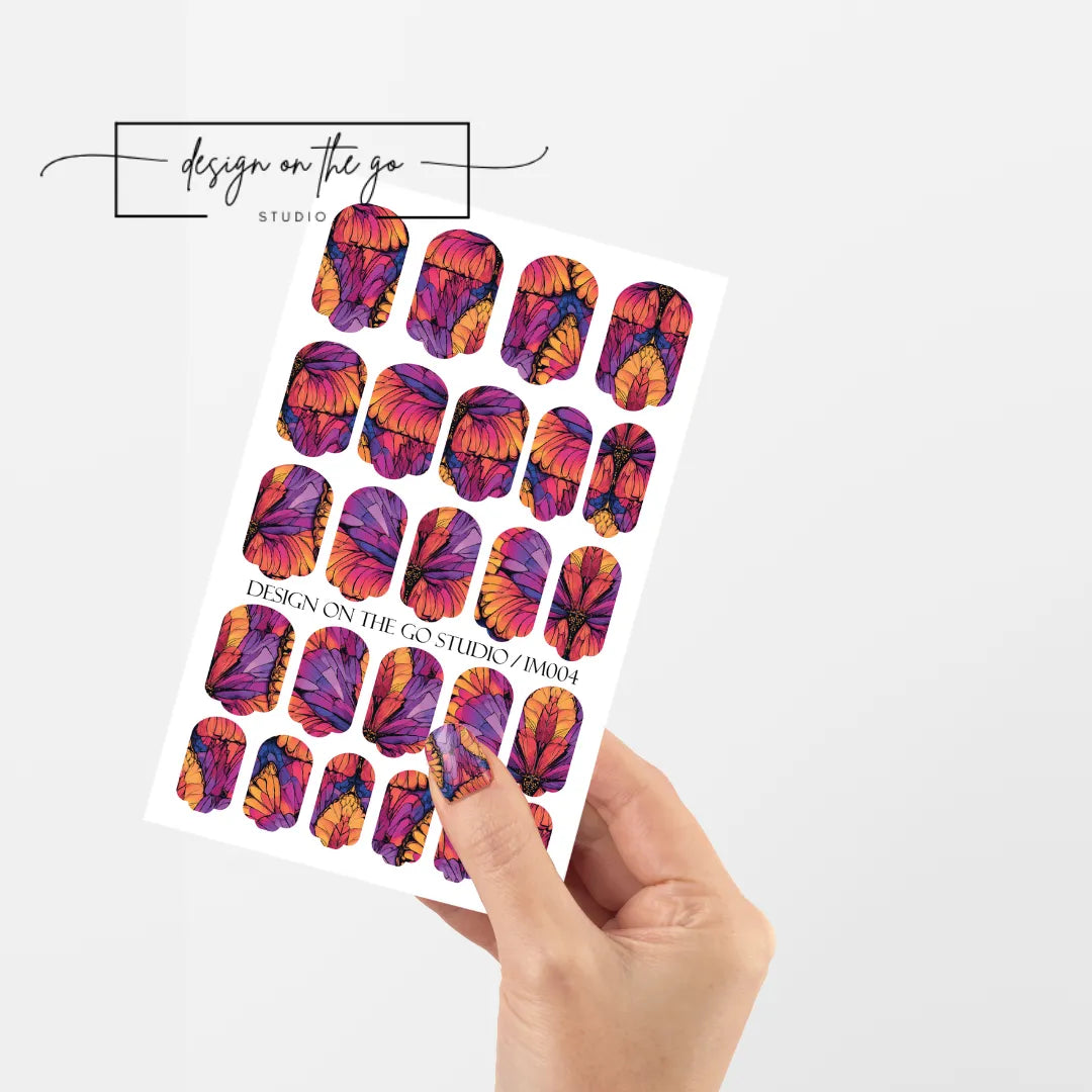 #type_manicure single hand with beautifully manicured nails with nail wraps holding full nail wraps sheet.