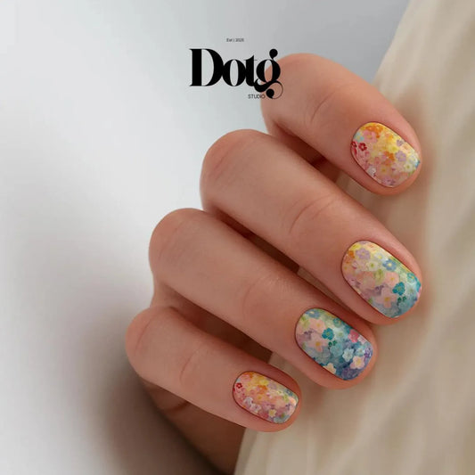 Hand with colourful floral nail art on a plain background