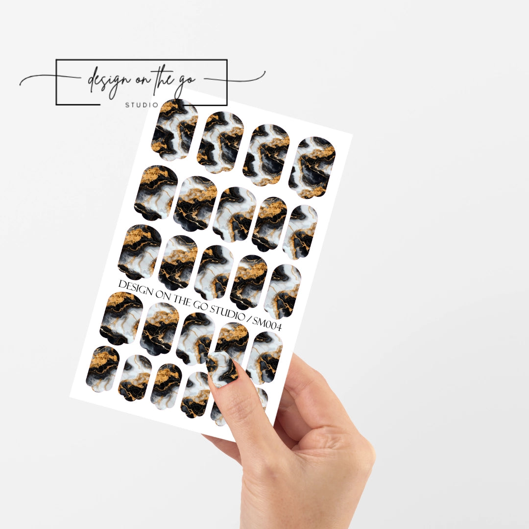 #type_manicure single hand with beautifully manicured nails with nail wraps holding full nail wraps sheet.