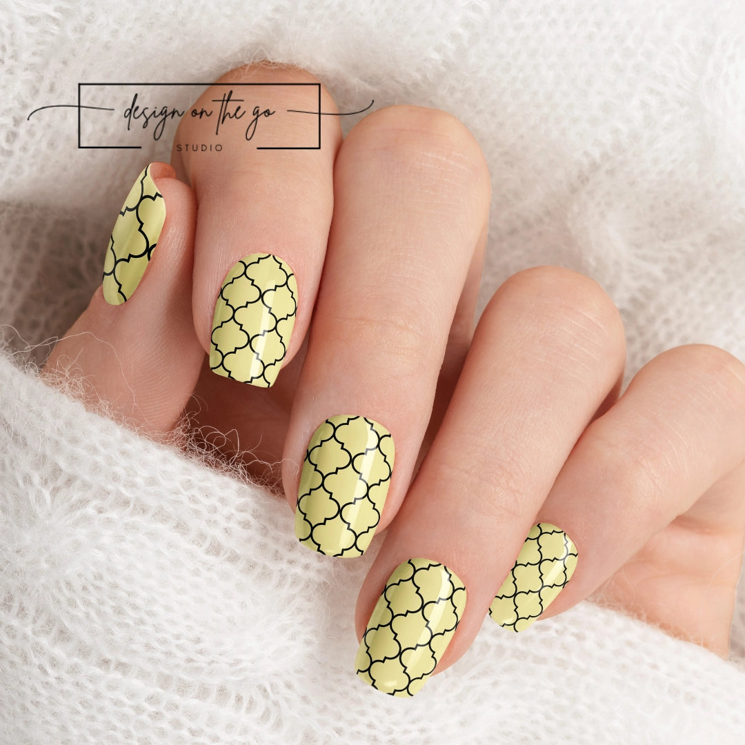 #type_manicure beautifully manicured hand showing nails with nail wraps applied on white sweater
