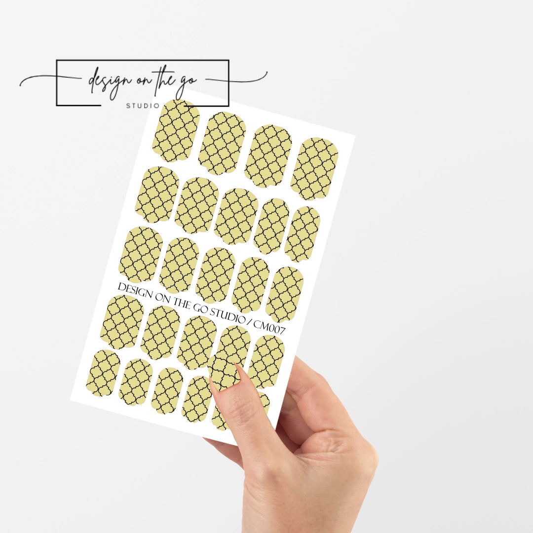 #type_manicure single hand with beautifully manicured nails with nail wraps holding full nail wraps sheet.