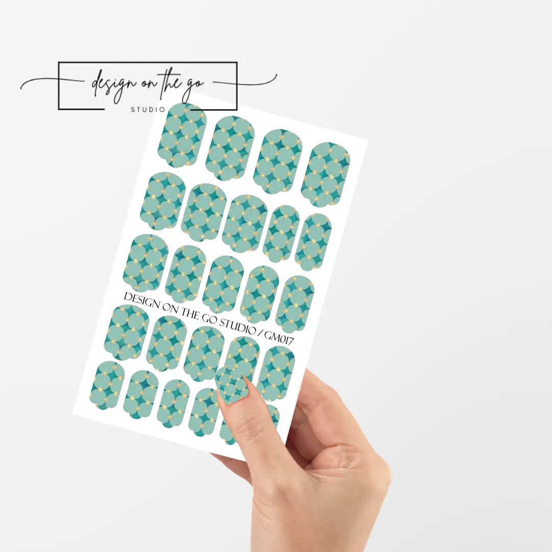 #type_manicure single hand with beautifully manicured nails with nail wraps holding full nail wraps sheet.