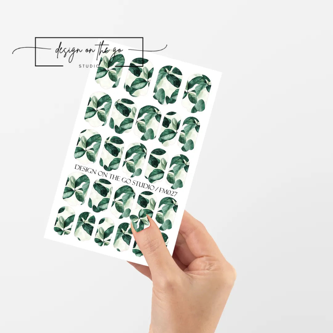 #type_manicure single hand with beautifully manicured nails with nail wraps holding full nail wraps sheet.