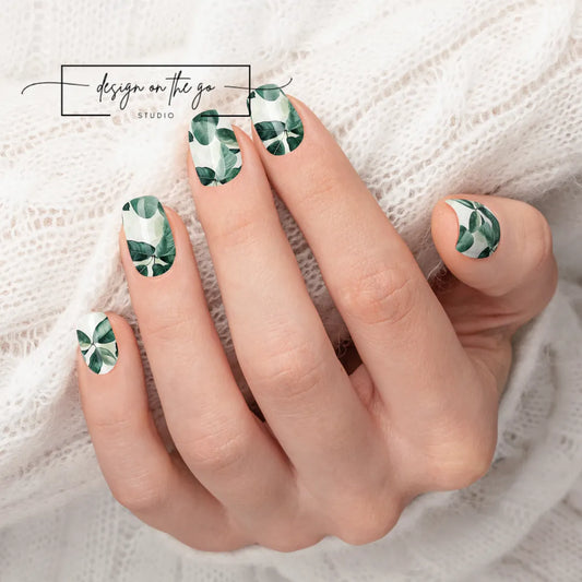 #type_manicure beautifully manicured hand showing nails with nail wraps applied on white sweater