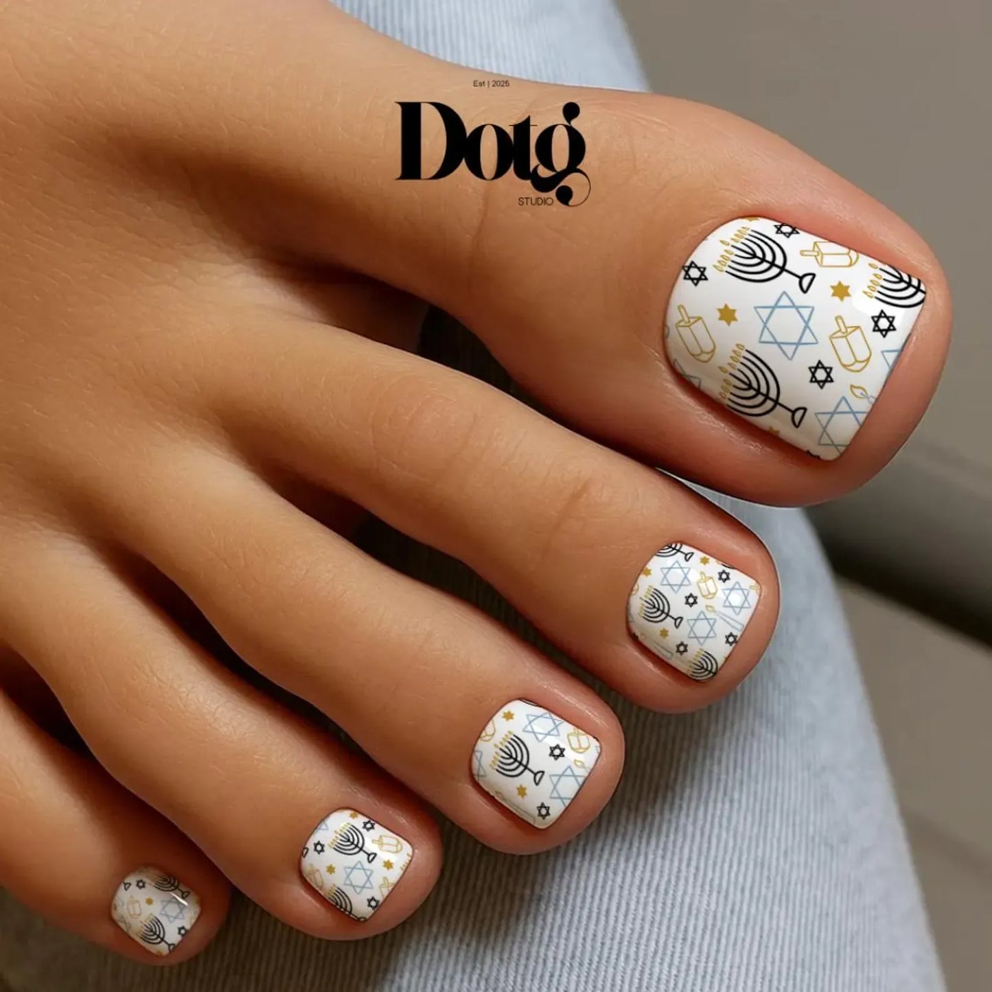 Nail art design on toes with geometric patterns.