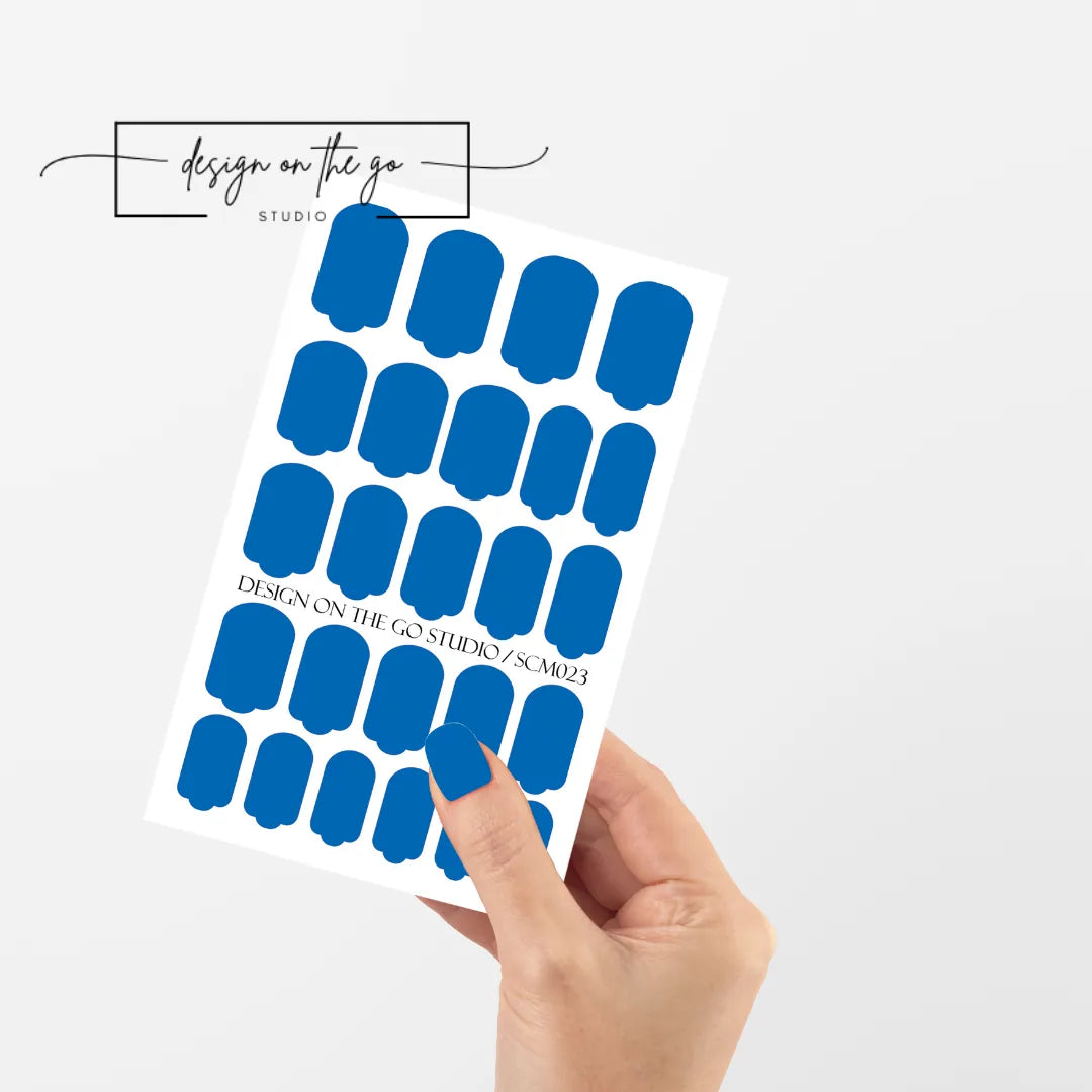 #type_manicure single hand with beautifully manicured nails with nail wraps holding full nail wraps sheet.