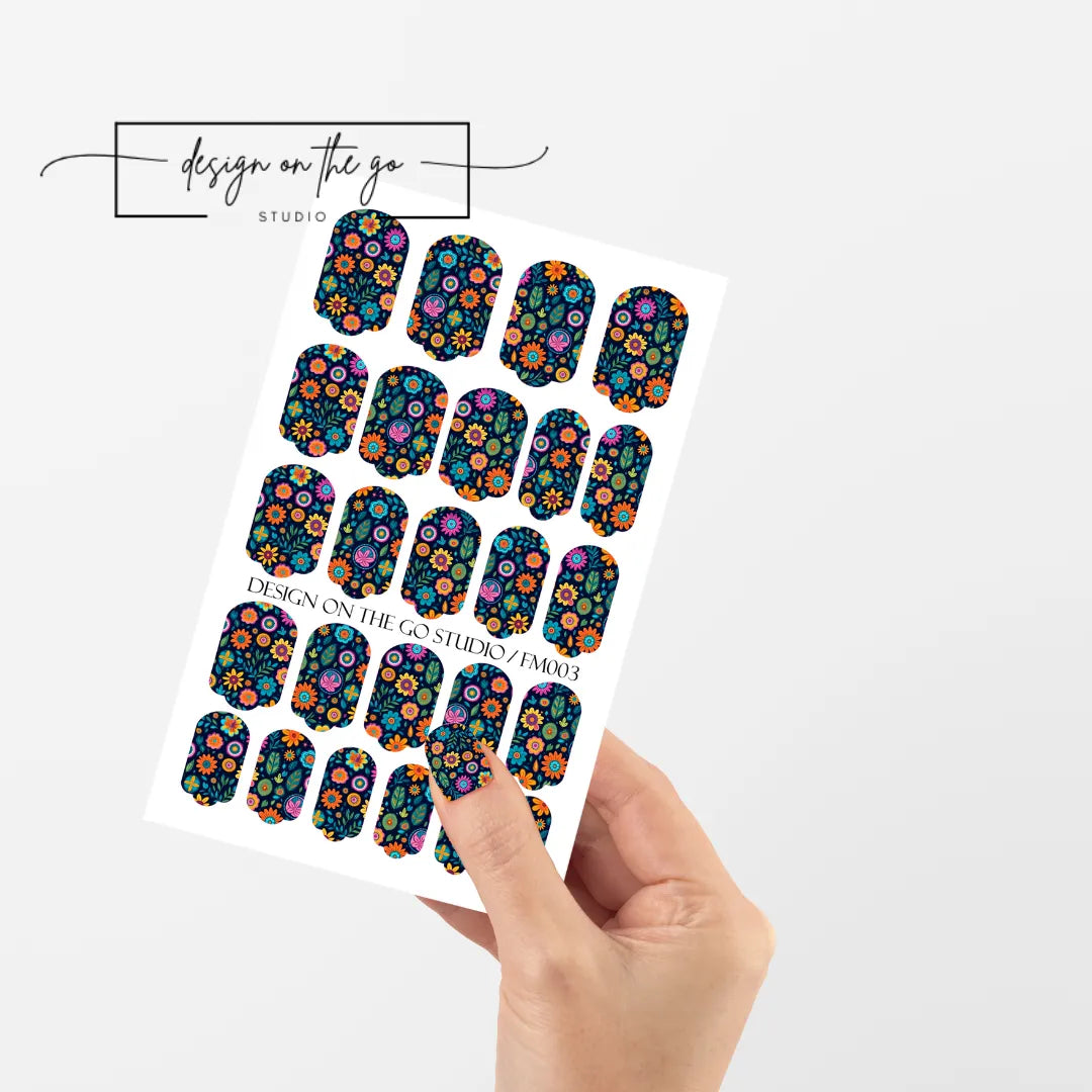 #type_manicure single hand with beautifully manicured nails with nail wraps holding full nail wraps sheet.