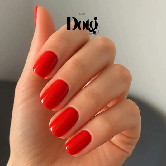 Hand with red nail polish on a neutral background, featuring the Dotg Studio logo.