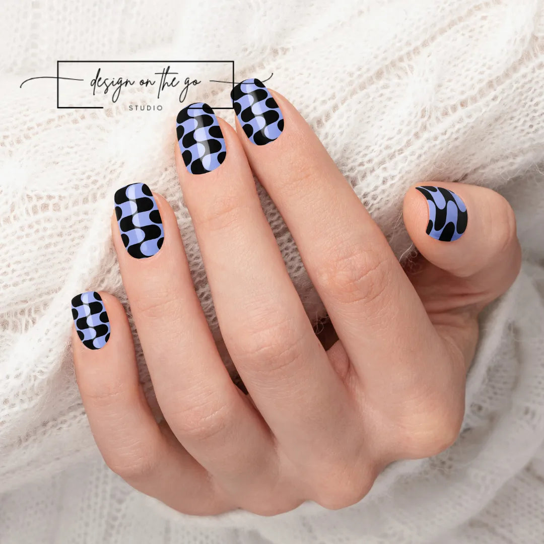 #type_manicure beautifully manicured hand showing nails with nail wraps applied on white sweater