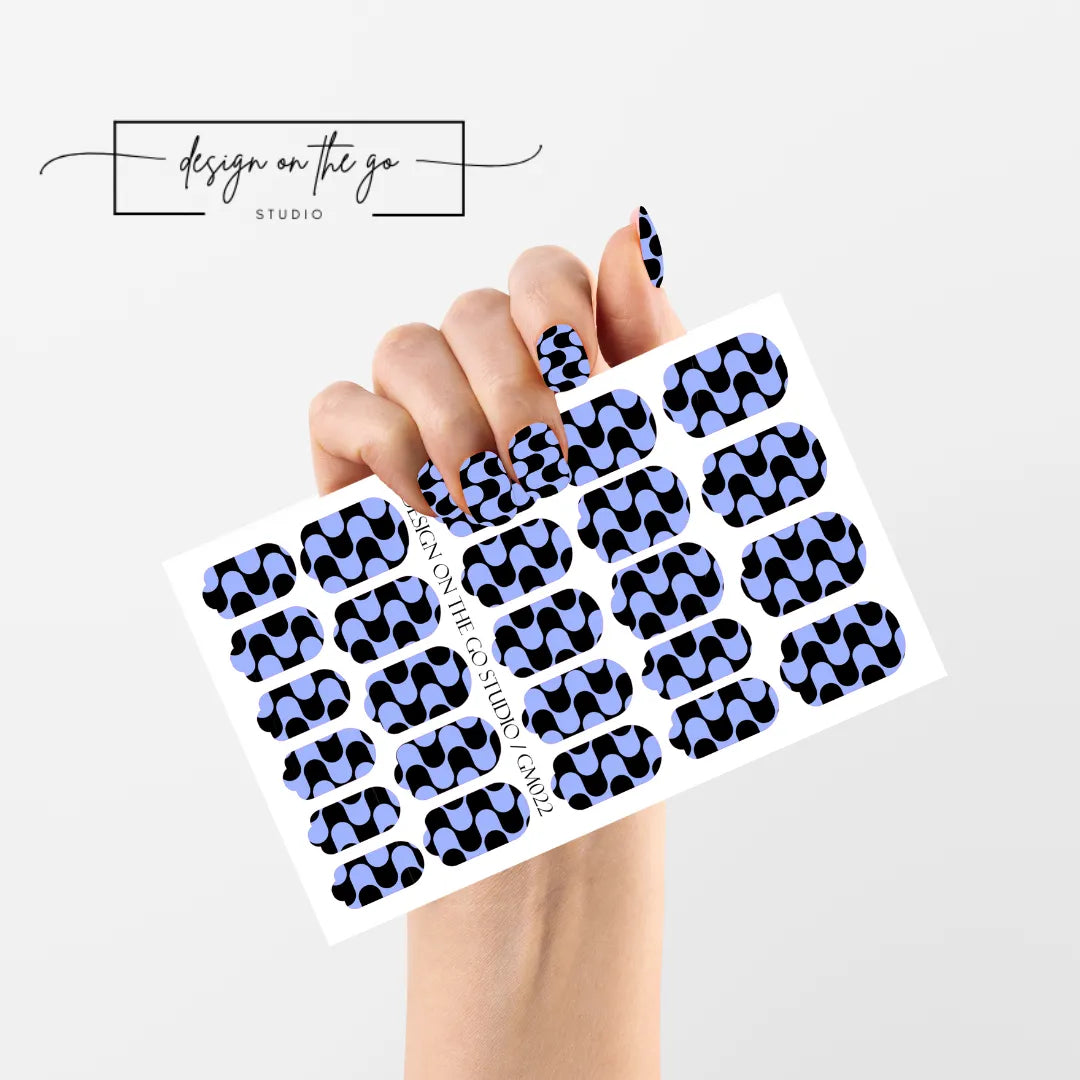 #type_manicure single hand with beautifully manicured nails with nail wraps holding full nail wraps sheet.