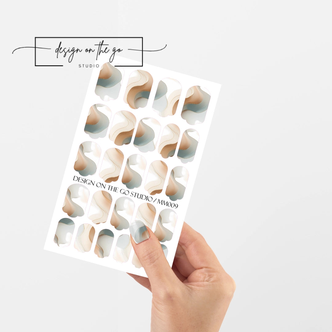 #type_manicure single hand with beautifully manicured nails with nail wraps holding full nail wraps sheet.