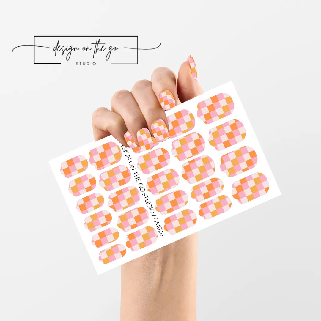 #type_manicure single hand with beautifully manicured nails with nail wraps holding full nail wraps sheet.