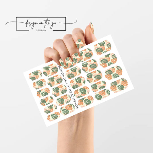 #type_manicure single hand with beautifully manicured nails with nail wraps holding full nail wraps sheet.