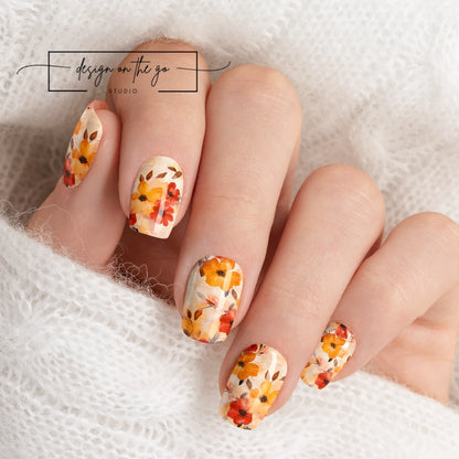 #type_manicure beautifully manicured hand showing nails with nail wraps applied on white sweater
