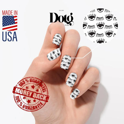 Hand with black and white nail art, Dotg Studio branding, Made in USA label, and money-back guarantee stamp.