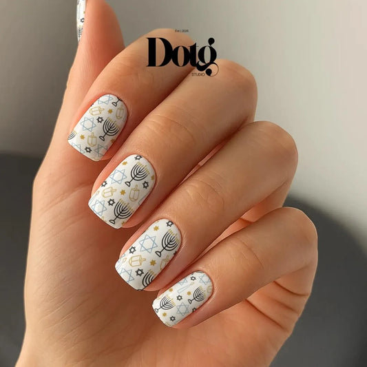 Nails with menora, dreidel and geometric pattern on a neutral background