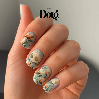 Hand with floral nail art and Doto Studio logo.