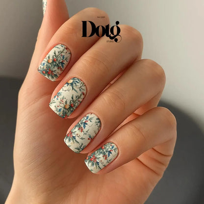 Manicured Hand with christmas floral nail wraps nail design.