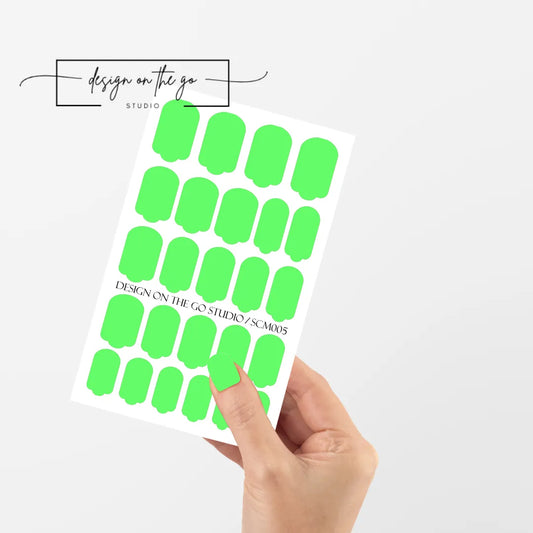 #type_manicure single hand with beautifully manicured nails with nail wraps holding full nail wraps sheet.