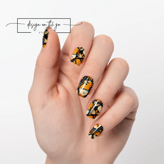 #type_manicure one hand showing beautifully manicured nail with nail wraps applied on white background