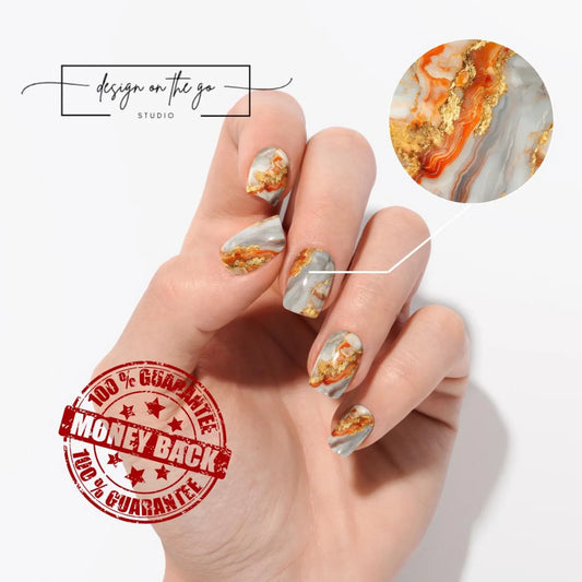 Hand with marbleized nail art and 'Design on the Go Studio' branding.