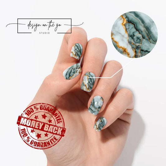 Hand with marble nail design and 'Design on the Go Studio' branding.