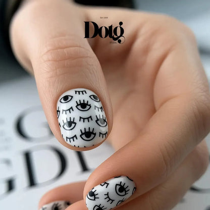 Nail art with black eye designs on white background