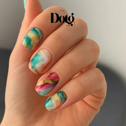 Hand with colourful marble nail art on blurred background