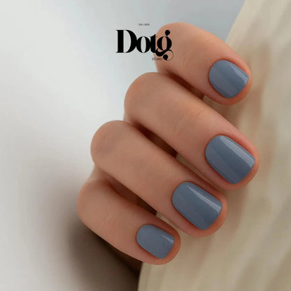 Hand with gray nail polish on a plain background, featuring the Doto Studio logo.