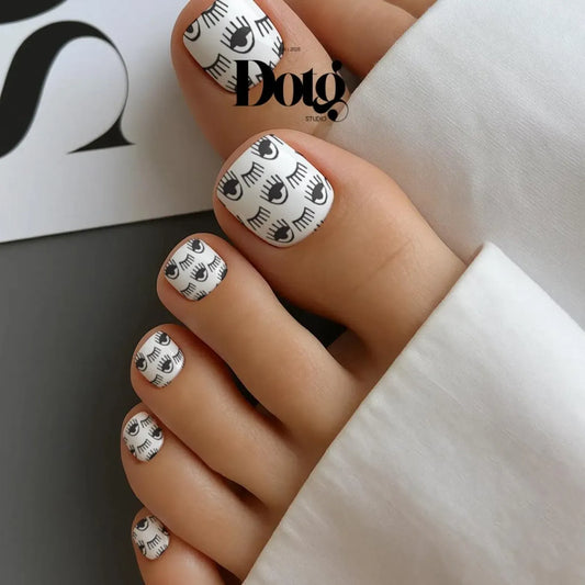 Toes with black & white eye wink pattern.