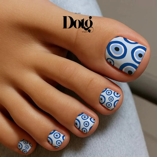 Nails wraps with blue and white pattern on a foot