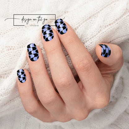 #type_manicure beautifully manicured hand showing nails with nail wraps applied on white sweater