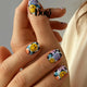 Nails with smiley face design on a neutral background