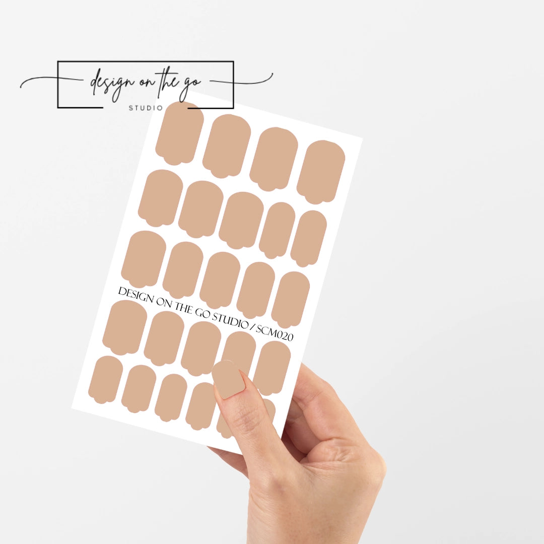 #type_manicure single hand with beautifully manicured nails with nail wraps holding full nail wraps sheet.