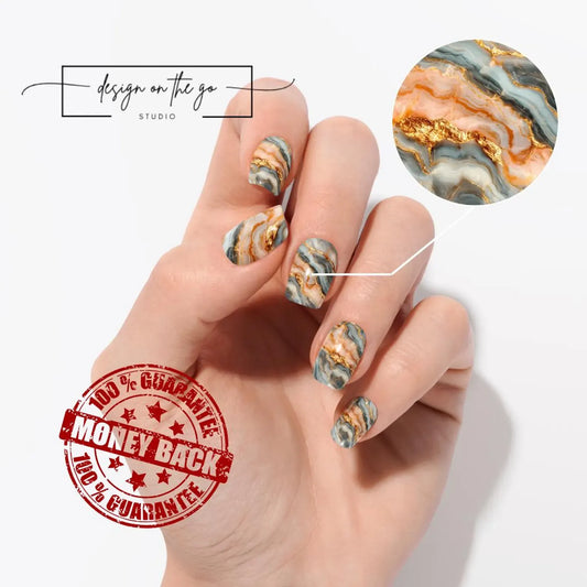Hand with marbleized nail art and 'Design on the Go Studio' branding.