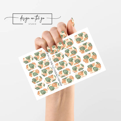 #type_manicure single hand with beautifully manicured nails with nail wraps holding full nail wraps sheet.