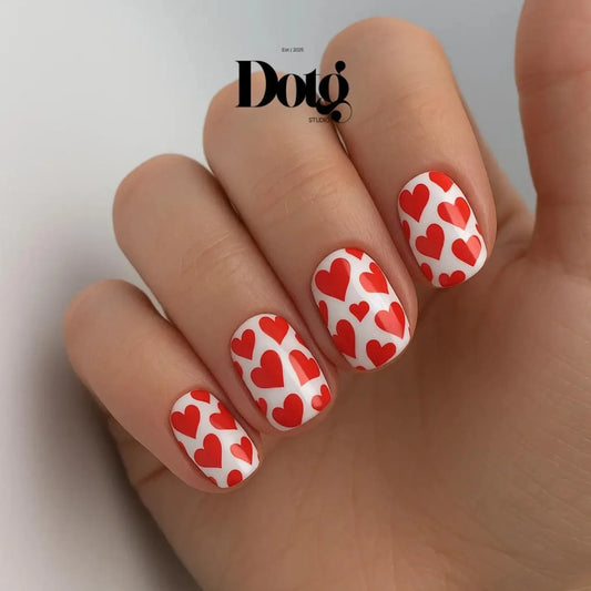 Nails with red heart pattern on a white background, featuring the Dotg Studio brand.